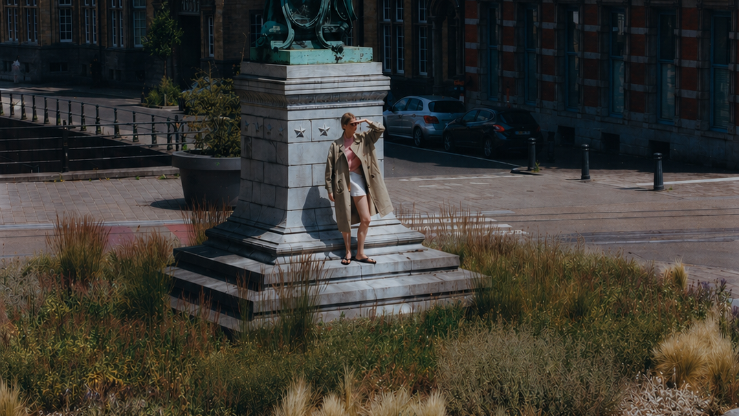 Statue in a public square with historical buildings in the background